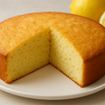 A-bright,-golden-brown-lemon-loaf-cake-drizzled-with-a-glossy-white-lemon-glaze,-showing-a-moist,-tender-crumb